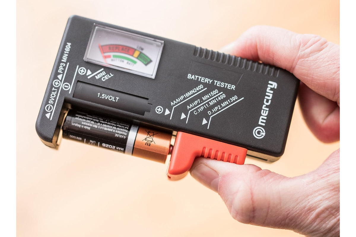Hand testing an AA battery in the Mercury analogue battery tester