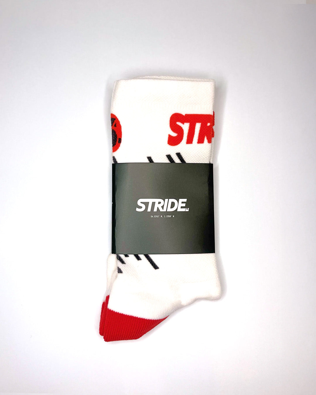 Stride Race Core running sock folded in its black STRIDE card sleeve