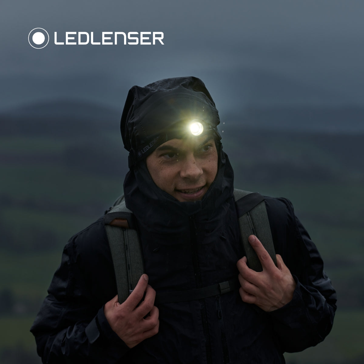 Walker in a waterproof hood in the rain wearing the Ledlenser MH10 SE