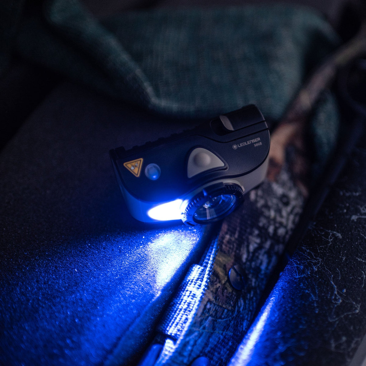 Ledlenser MH8 lamp head giving off blue light in the dark
