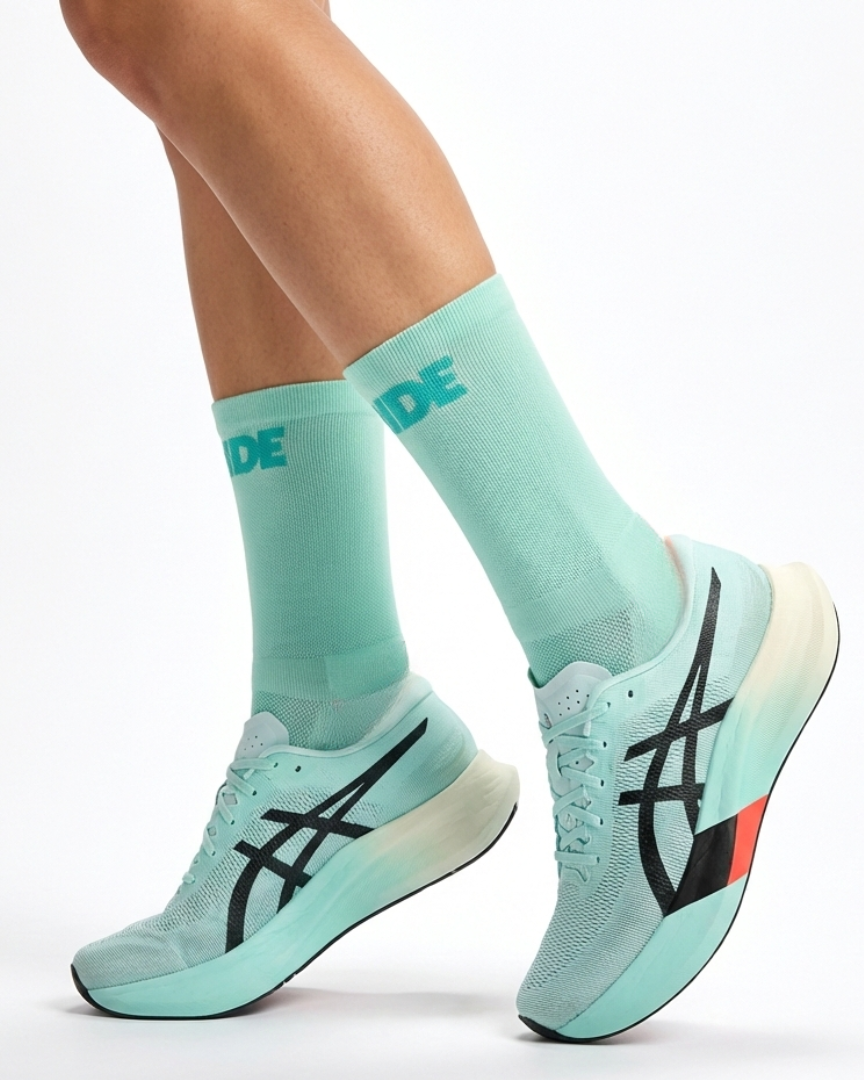 Runner's lower legs in Stride Ocean Wave half crew running socks with mint running shoes