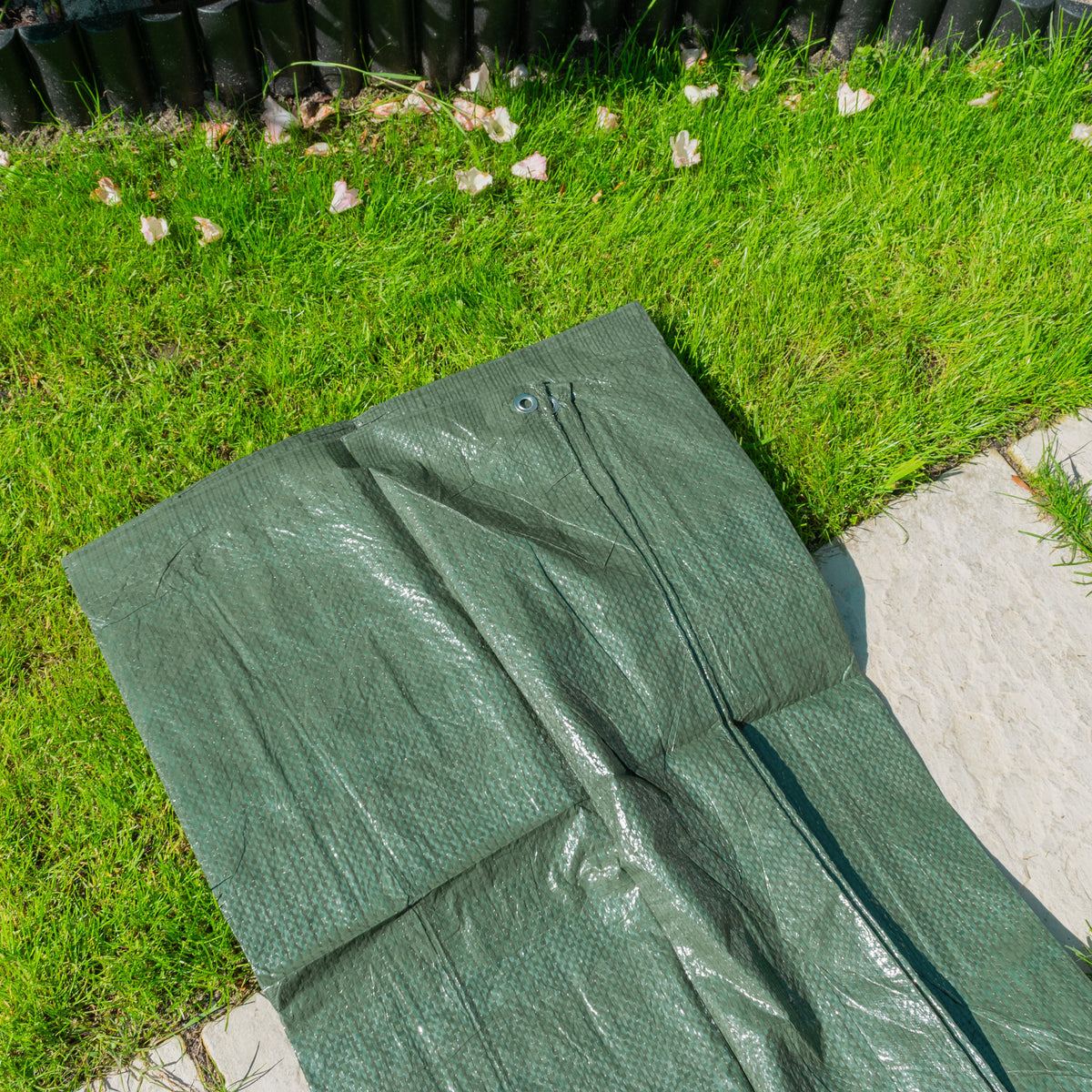 Green S-Grade Tarpaulin with 10m of 6mm Bungee Rope laid on a lawn and garden path