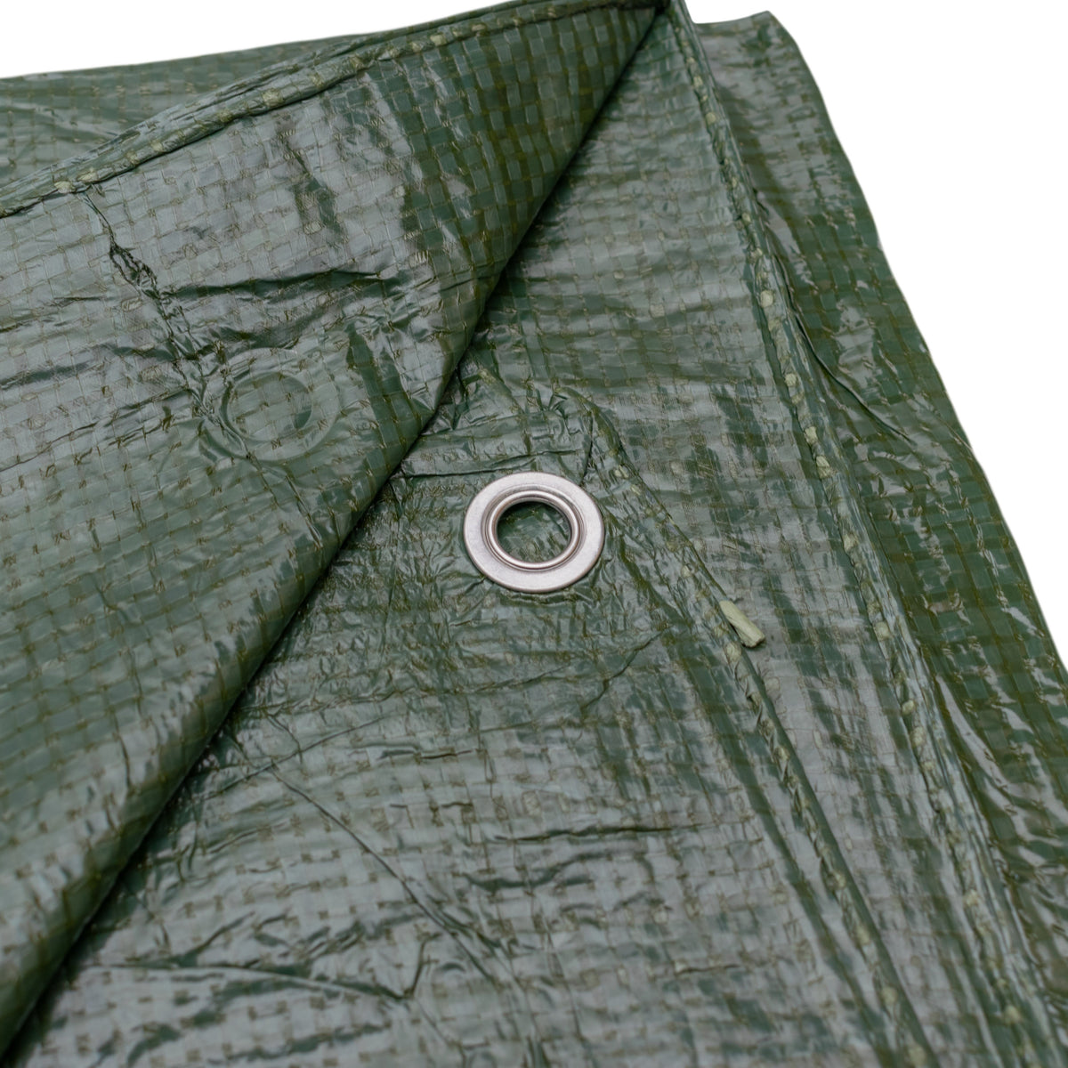 Close-up of an aluminium eyelet in the hemmed edge of the Green S-Grade Tarpaulin 2m x 2m