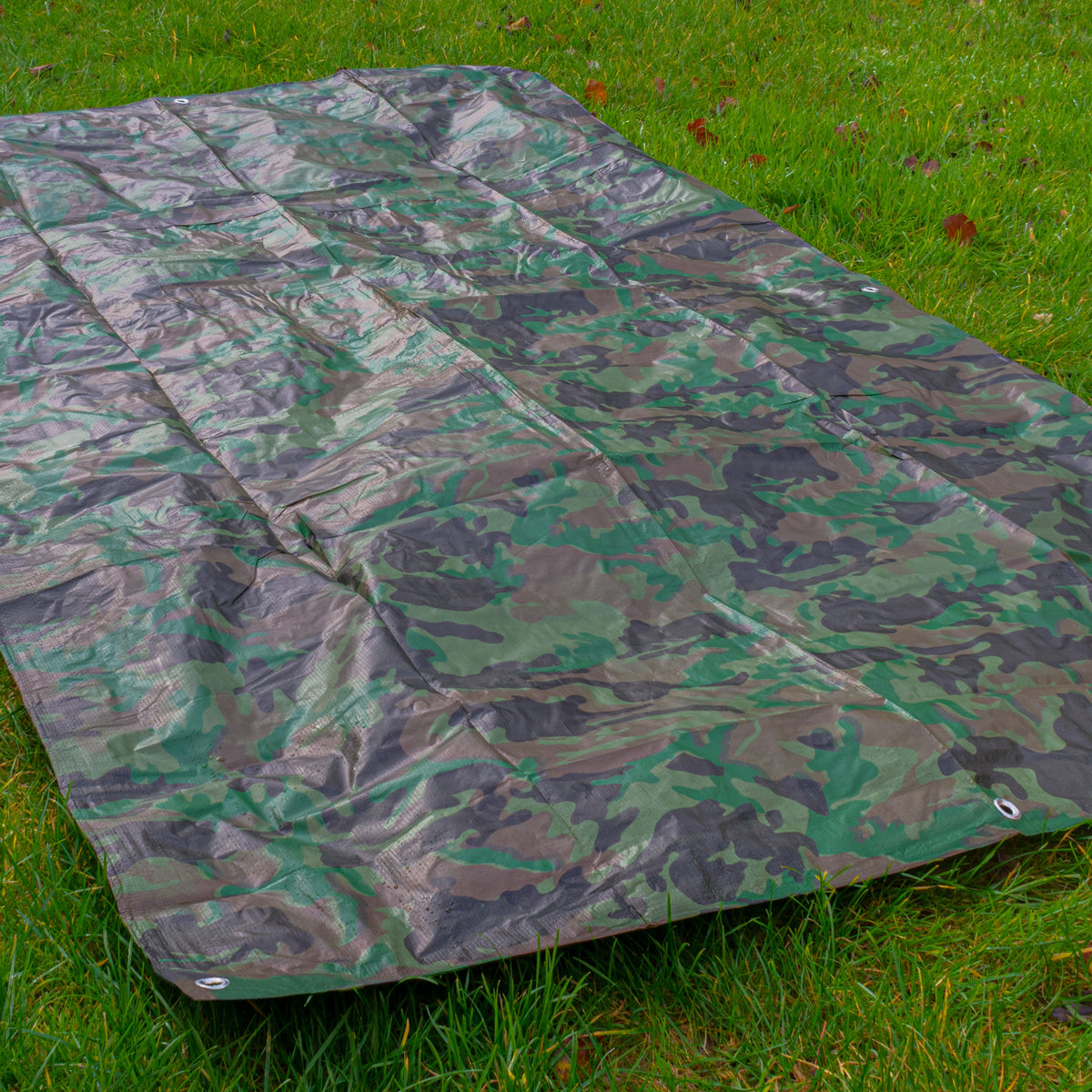 Camouflage M-Grade Tarpaulin 1.5m x 2.4m spread out on a lawn