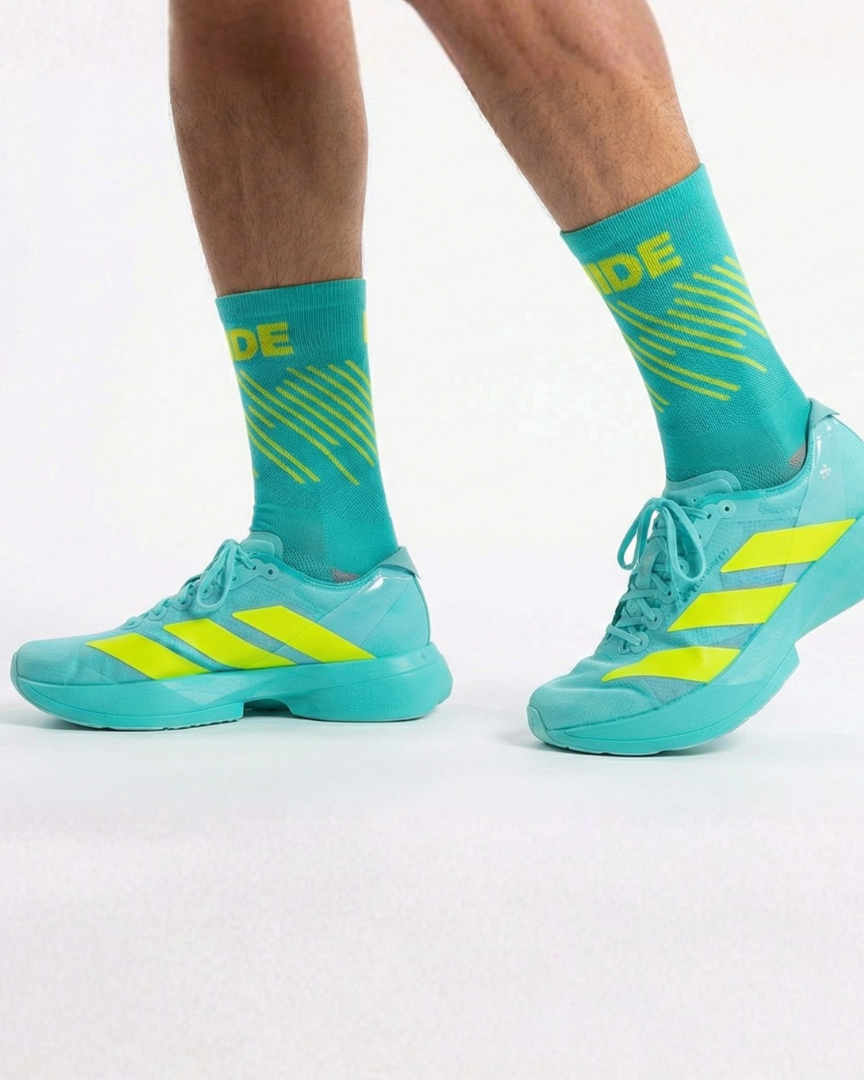 Runner's lower legs in Stride Lucid Strike half crew running socks with turquoise running shoes