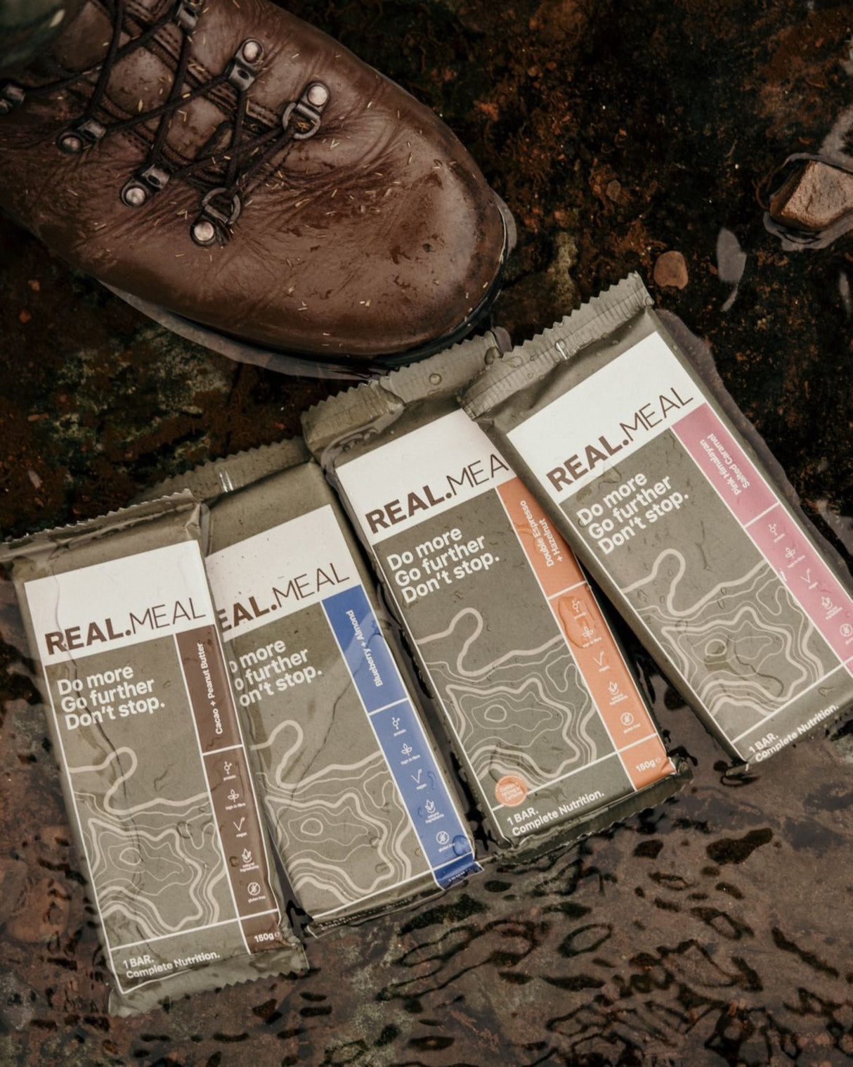 Real Meal Food Bar on the ground outdoors next to a boot