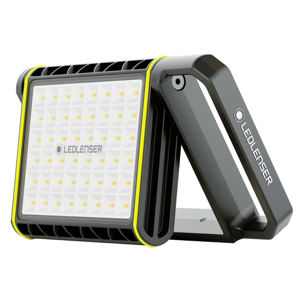 Ledlenser AF8R Work area light standing on its fold-out handle, showing the square panel of warm and cool white LEDs