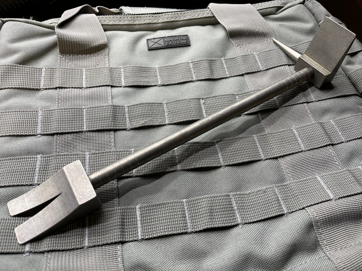 12 in Titanium Hooligan Bar lying on a kit bag with webbing panels