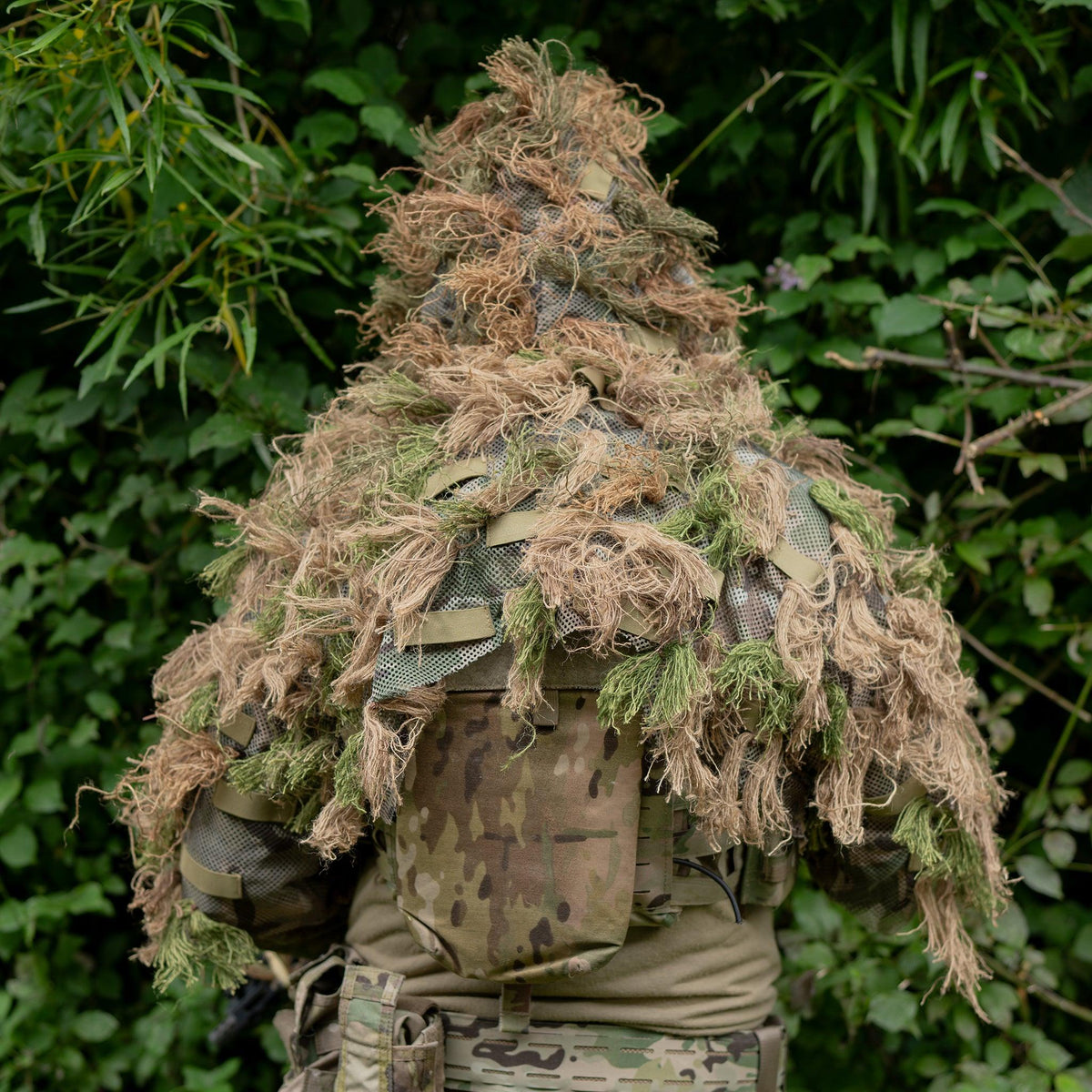 Rear of the head and shoulders ghillie suit, showing the Viper mesh base shroud and the rows of olive elastic garnish loops sewn across it