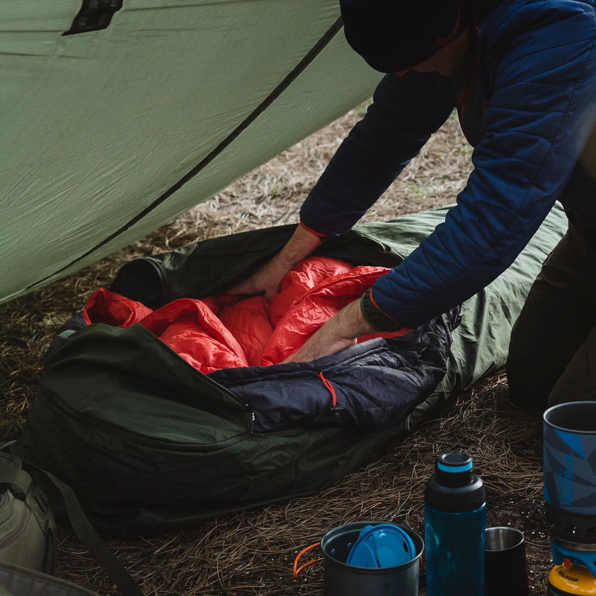 Highlander Hawk Waterproof Bivvy Bag being used outdoors - with sleeping bag