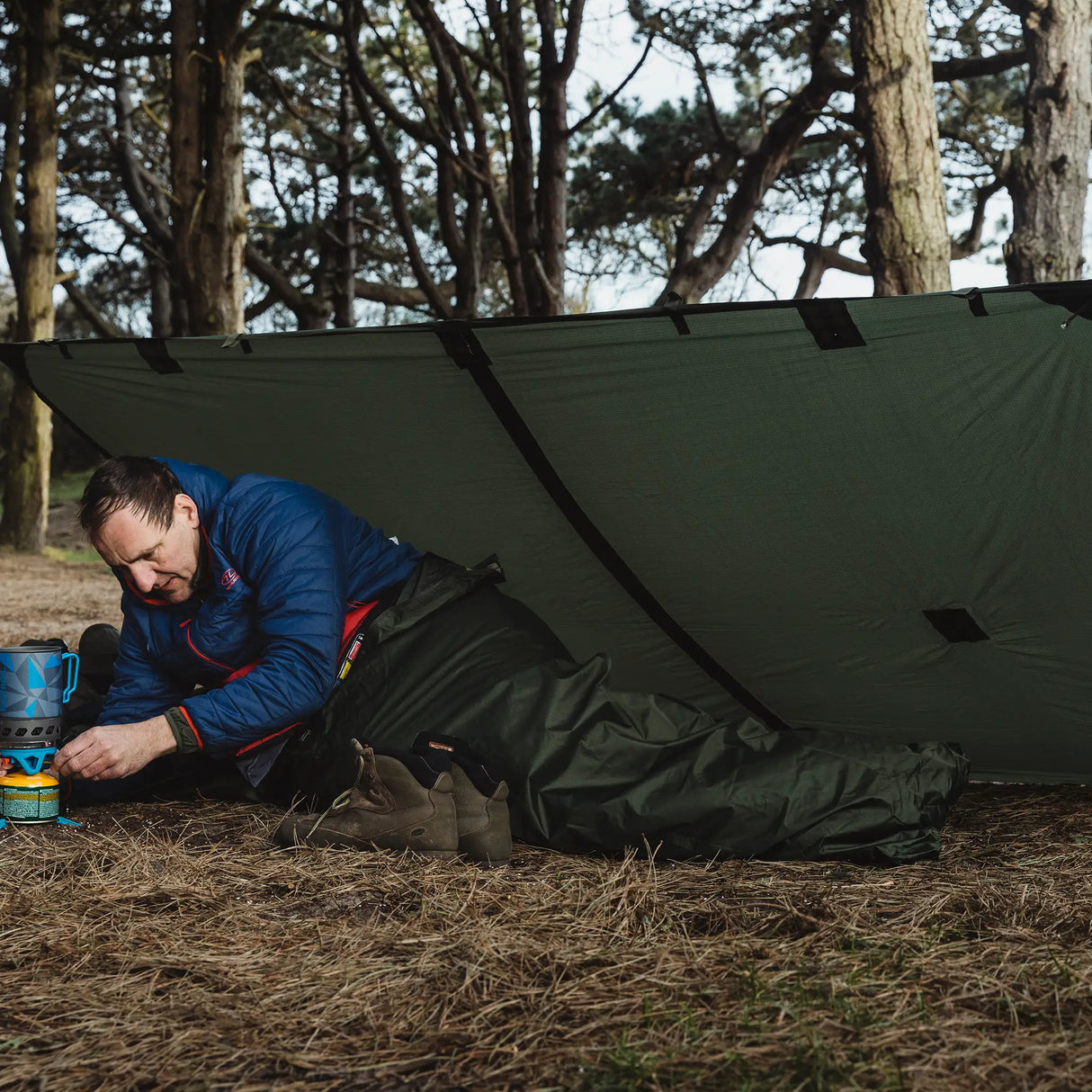 Highlander Hawk Waterproof Bivvy Bag being used outdoors - with a basha