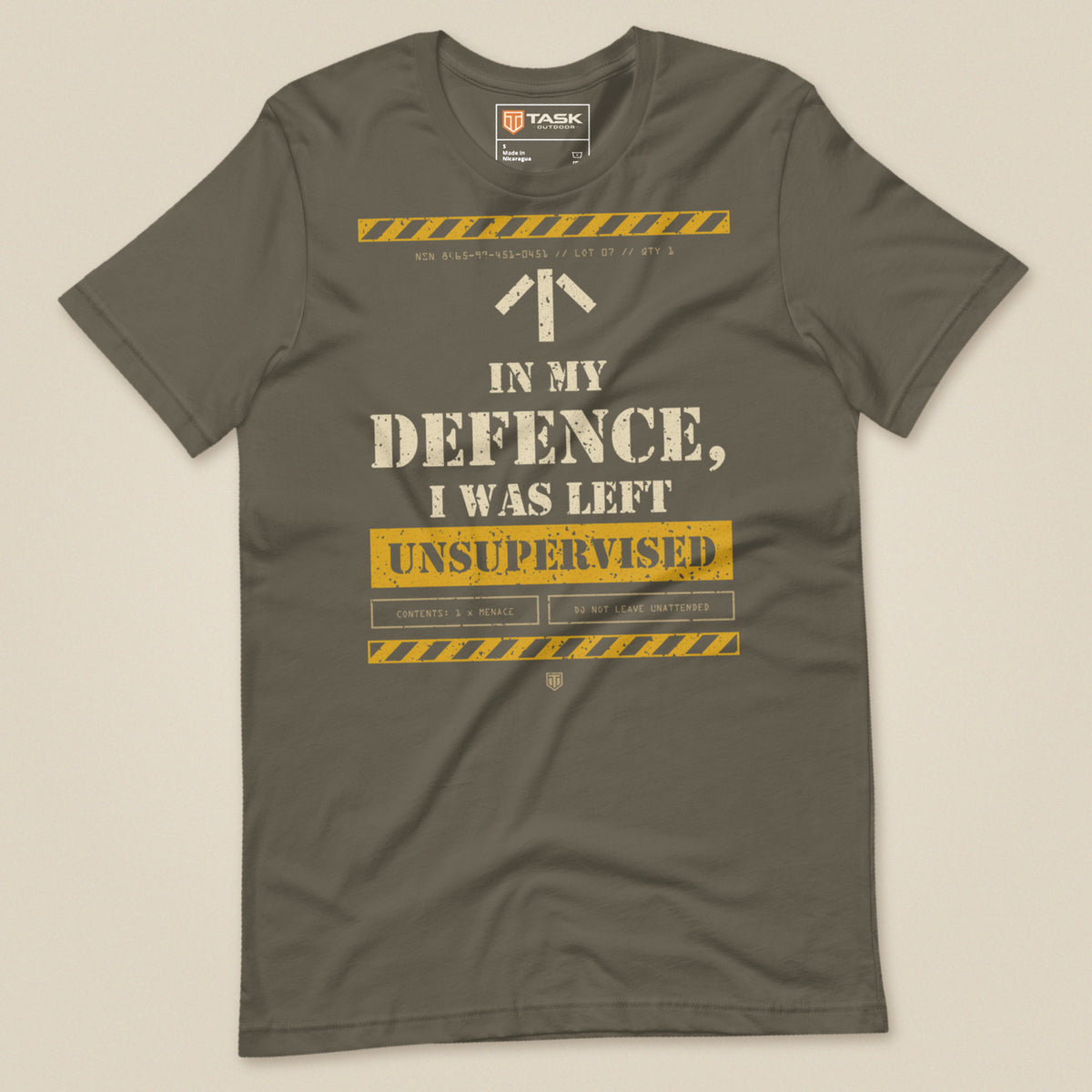 Task "In My Defence, I Was Left Unsupervised" T-shirt in Army, laid flat, front view with distressed stencil slogan and hazard stripes