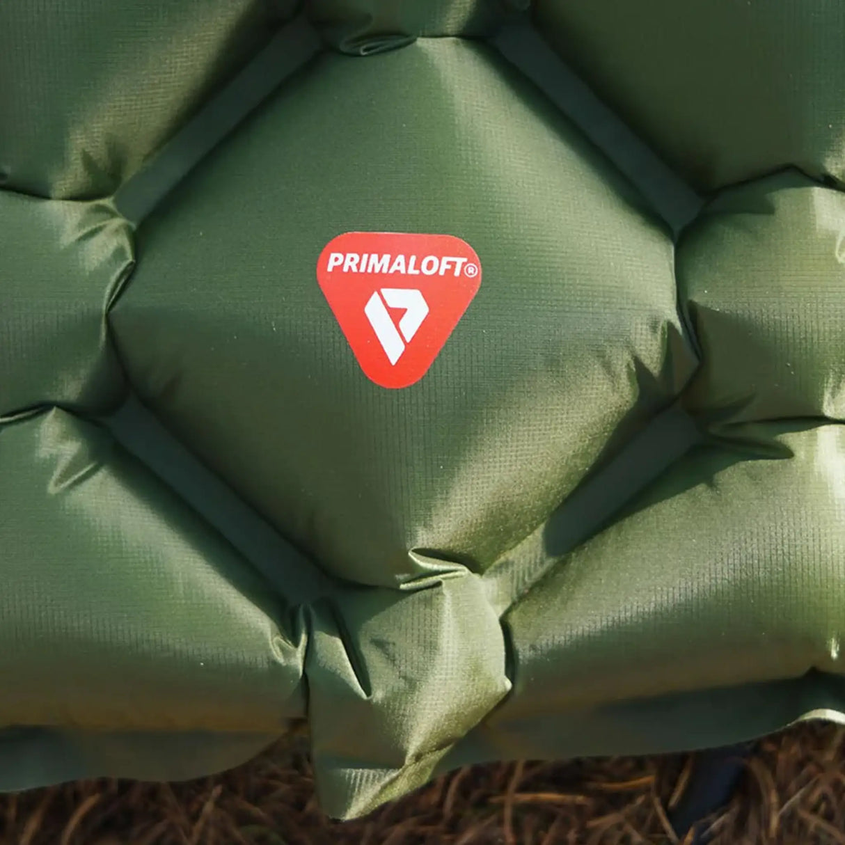 Highlander Nap-Pak Primaloft Insulated Inflatable Sleeping Mat close up of logo set outdoors