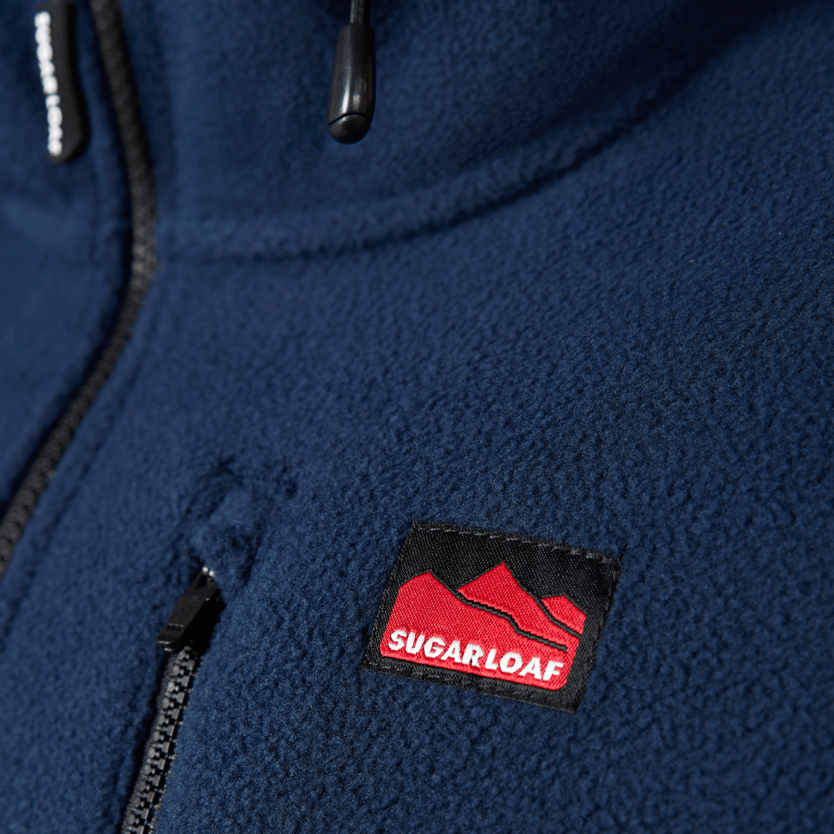 Sugar Loaf Shepherd Polar Fleece Hoodie in Navy Blue close up of chest logo