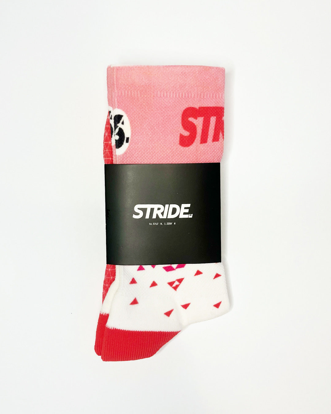 Stride Flash Pink running sock folded in its black STRIDE card sleeve