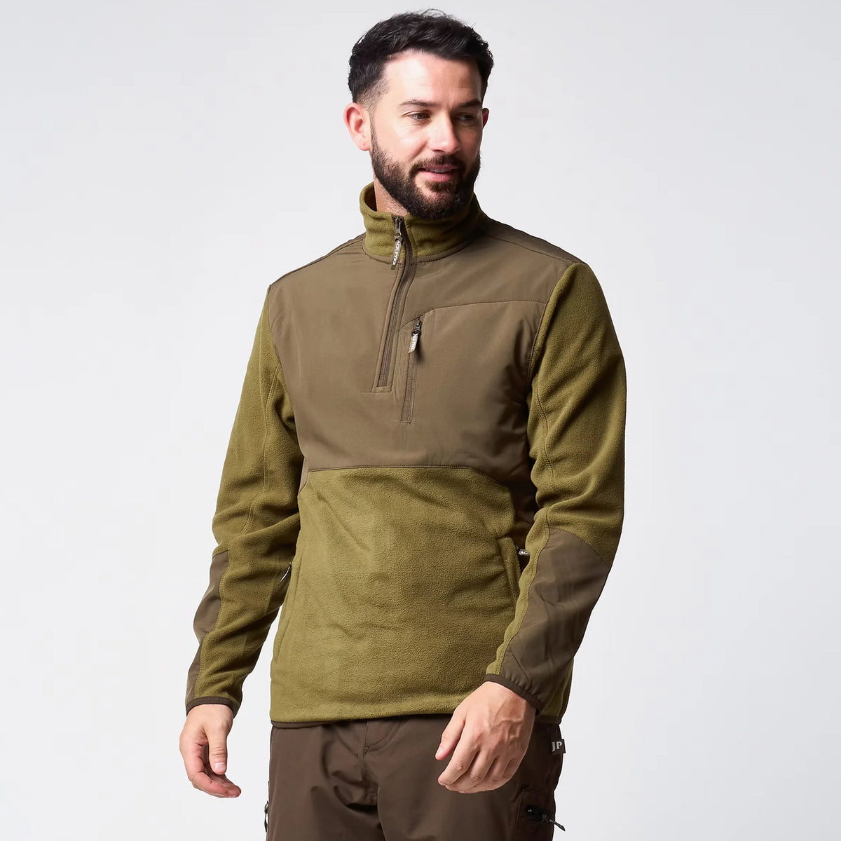 Jack Pyke Rannock Fleece Pullover in dark mustard worn by a model, front three-quarter view with the 1/4 zip closed