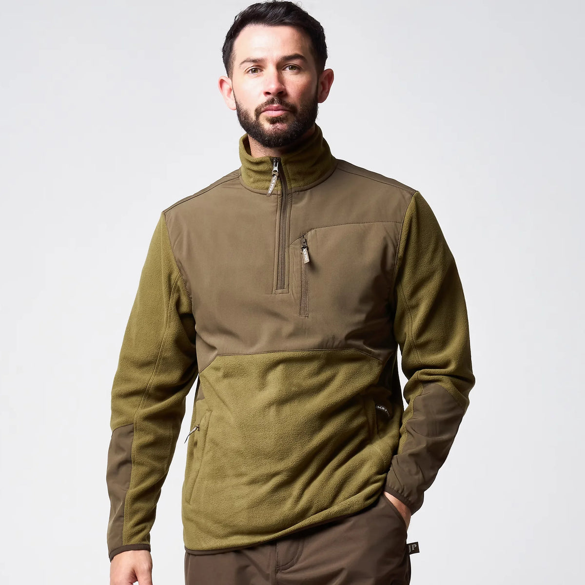 Jack Pyke Rannock Fleece Pullover in dark mustard worn by a model, front view showing the smooth contrast panels, 1/4 zip and zipped chest pocket