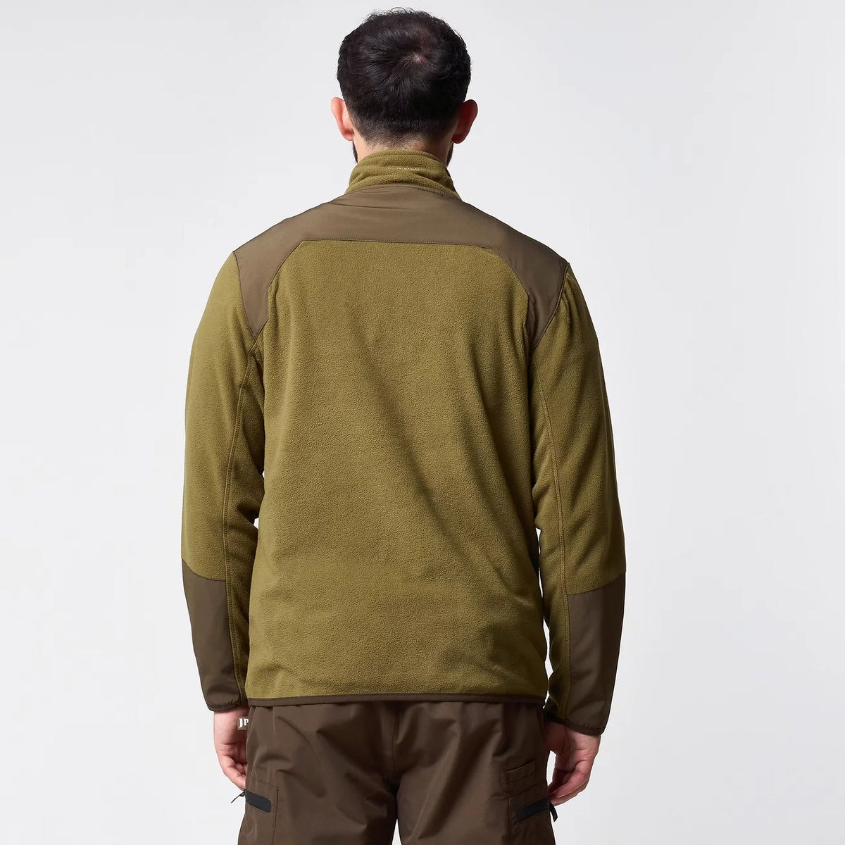 Jack Pyke Rannock Fleece Pullover in dark mustard worn by a model, back view showing the smooth contrast panels across the shoulders and forearms