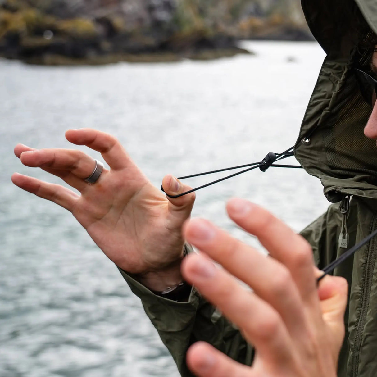 Highlander Stow & Go Pack Away Jacket - close up of adjustable hood pull cords outdoors