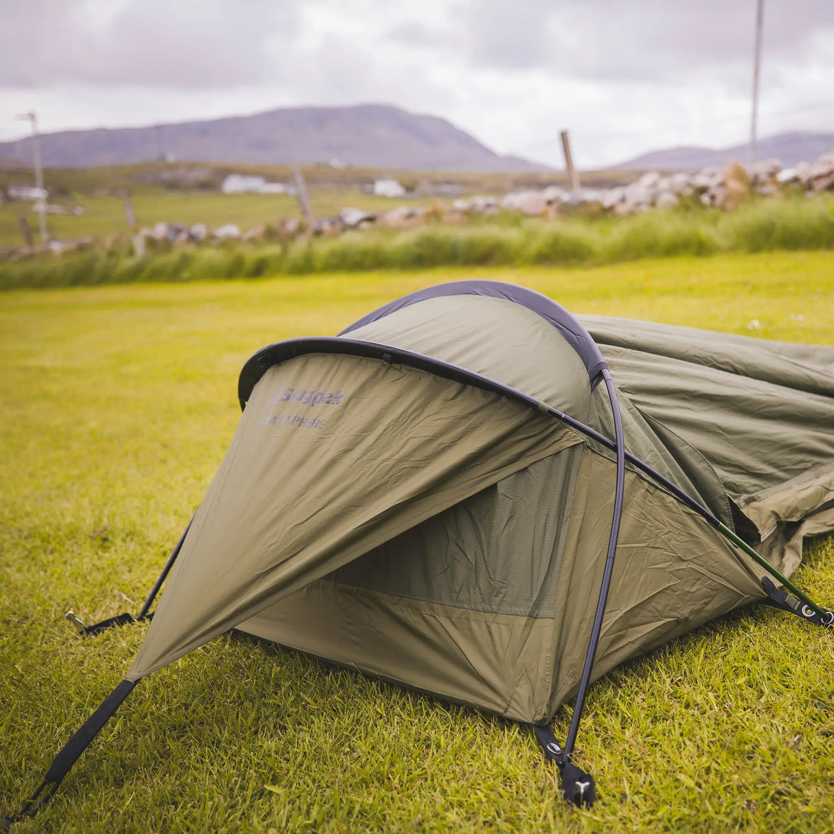 Snugpak Stratosphere WGTE Bivvi Shelter in Olive Green - angled view showing the single pole hoop and low tapered profile