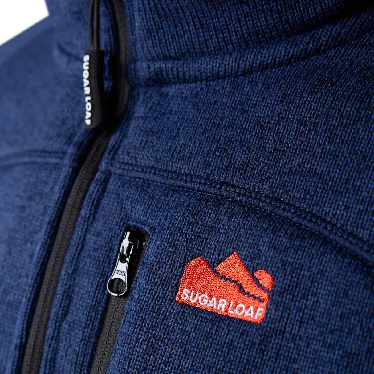 Sugar Loaf Fell Half Zip Fleece Top in Navy Blue close up of branding on chest