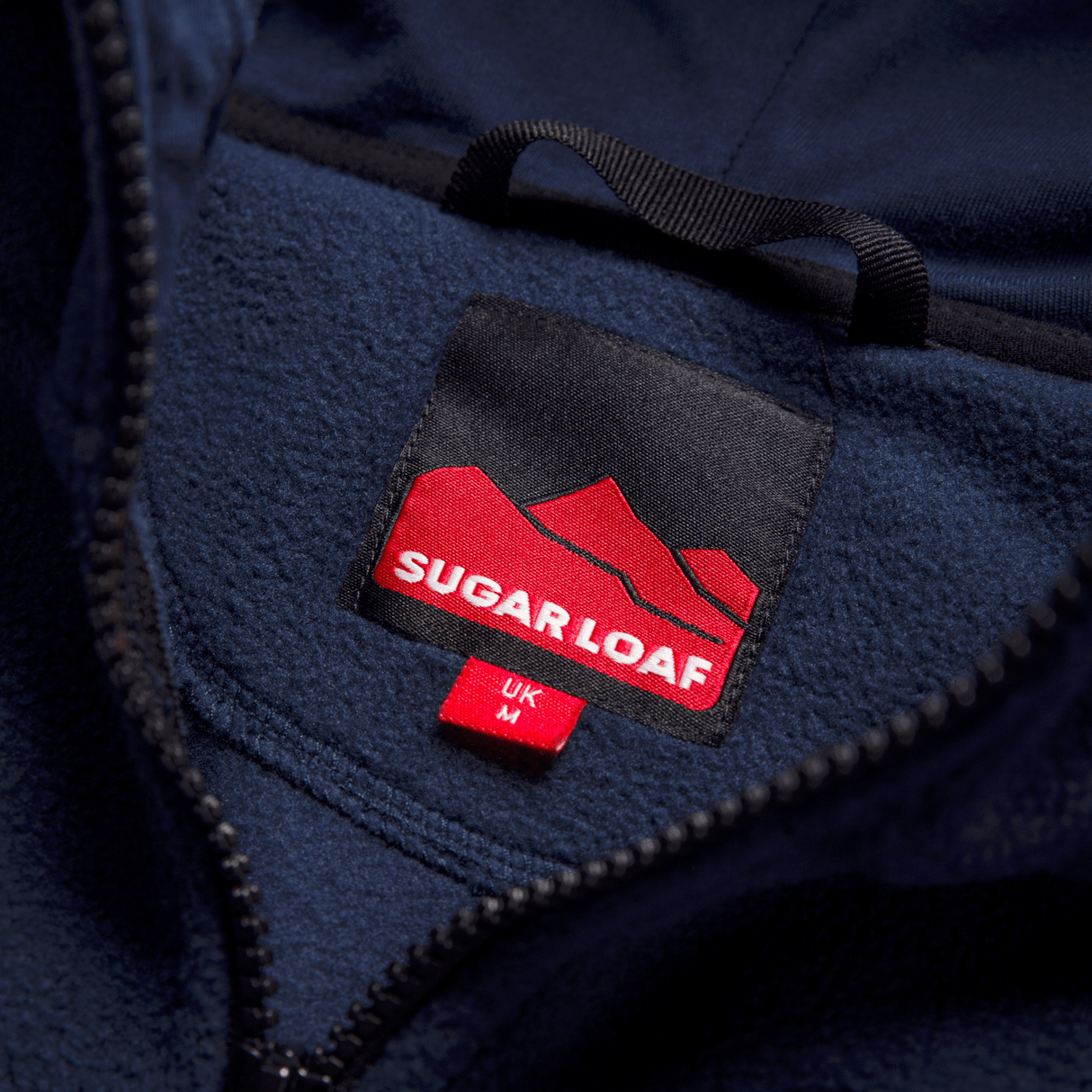 Sugar Loaf Shepherd Polar Fleece Hoodie in Navy Blue close up of brand logo