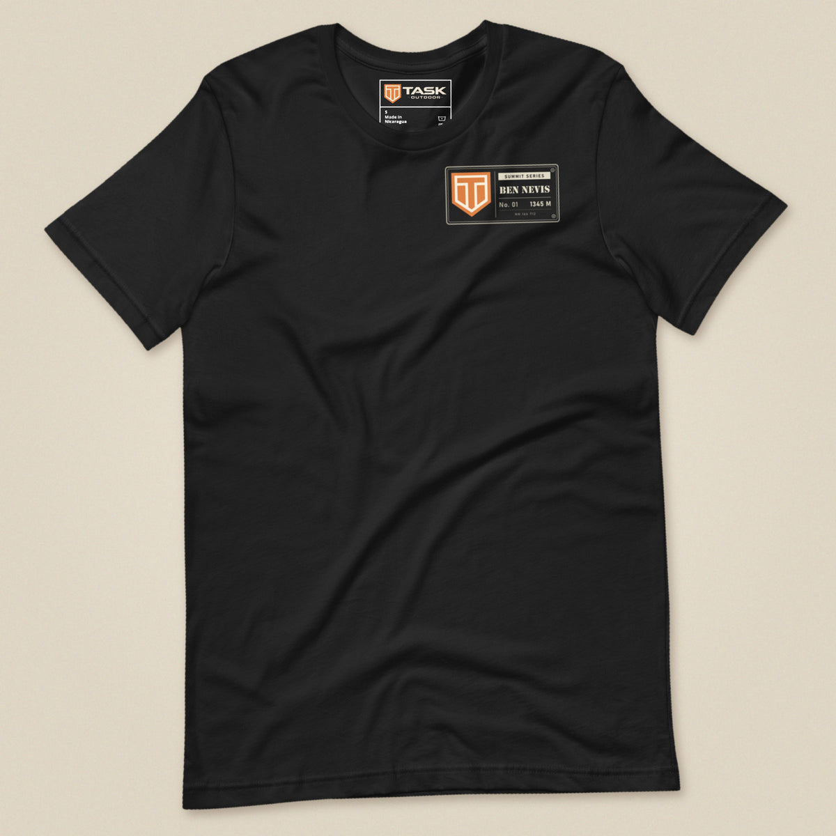Summit Series Ben Nevis T-Shirt in Vintage Black, laid flat, front view with the left-chest badge and Task Outdoor neck label