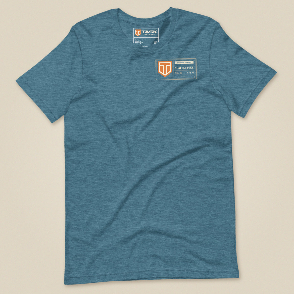 Summit Series Scafell Pike T-Shirt in Heather Deep Teal, laid flat, front view with the left-chest badge