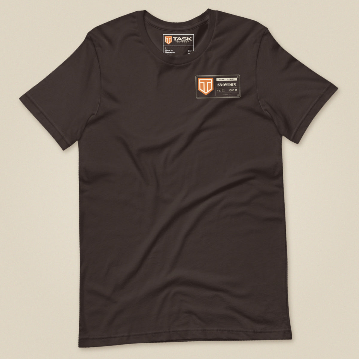 Summit Series Snowdon T-Shirt in Brown, laid flat, front view with the left-chest badge