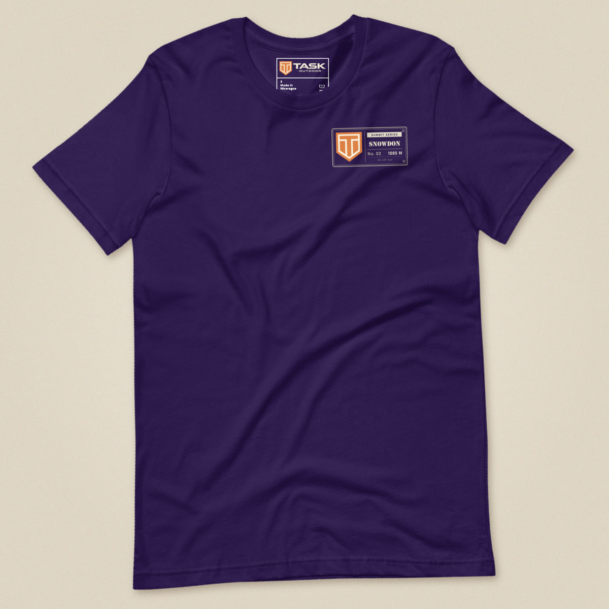 Summit Series Snowdon T-Shirt in Team Purple, laid flat, front view with the left-chest badge