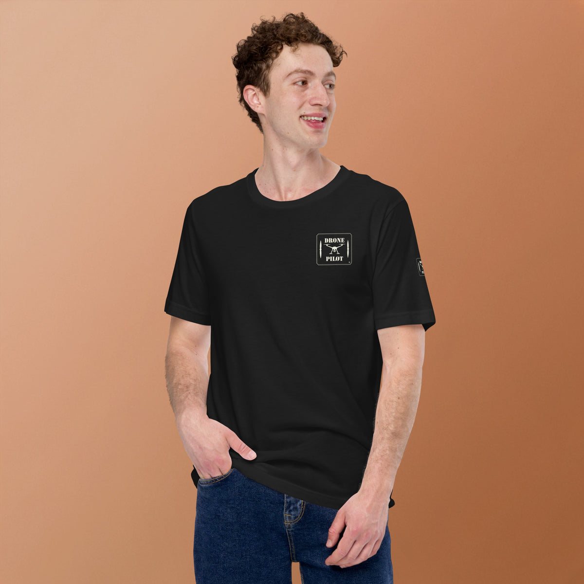 Man wearing the Drone Pilot T-shirt in Vintage Black with jeans, the small patch print on his left chest