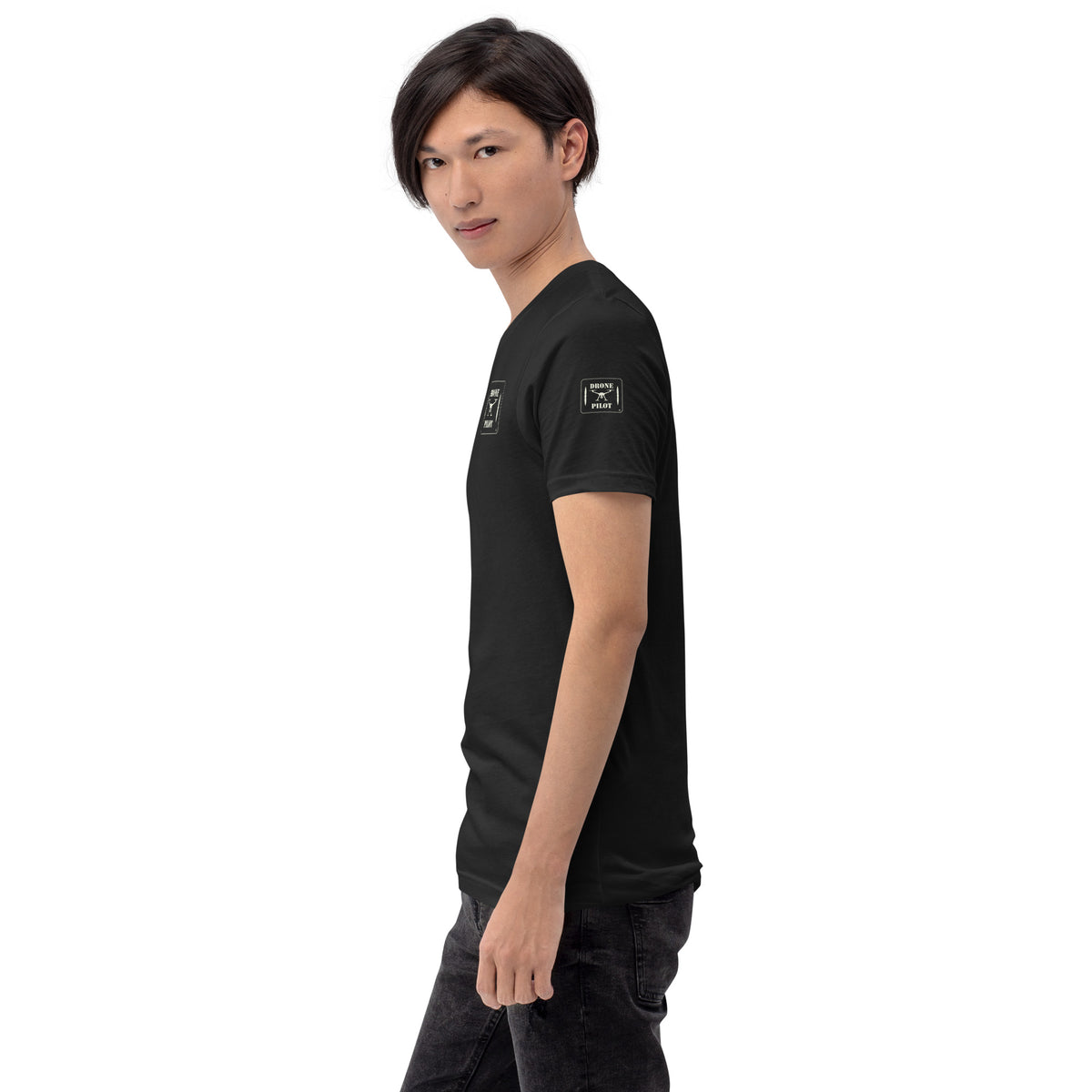 Side view of a man wearing the Vintage Black Drone Pilot T-shirt, with the small patch prints on the sleeve and chest