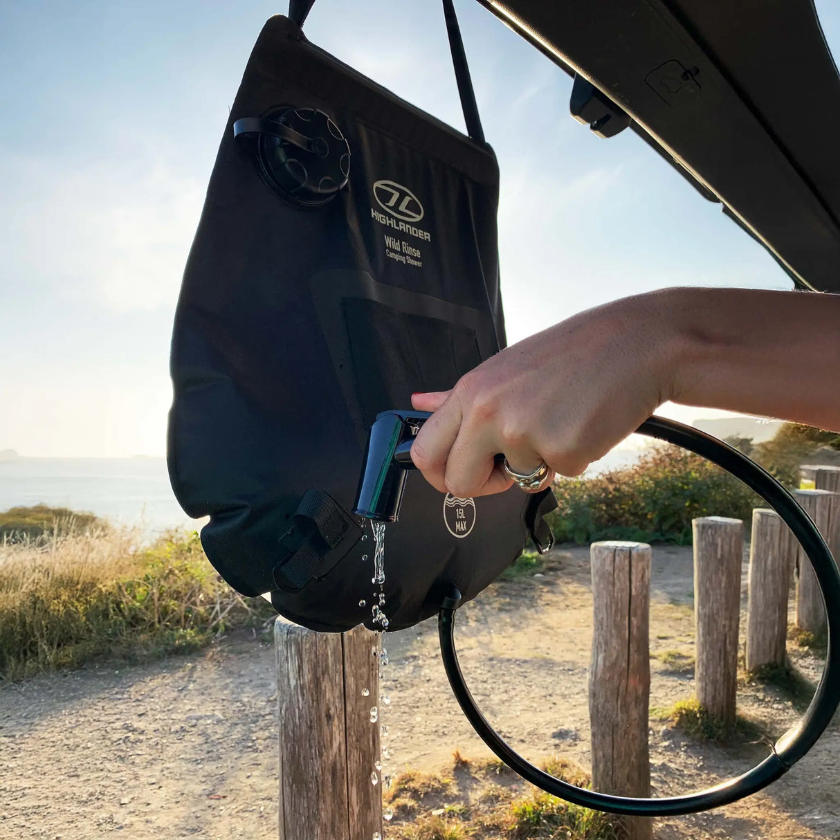 Highlander Wild Rinse Camping Solar Shower 15L in the outdoors