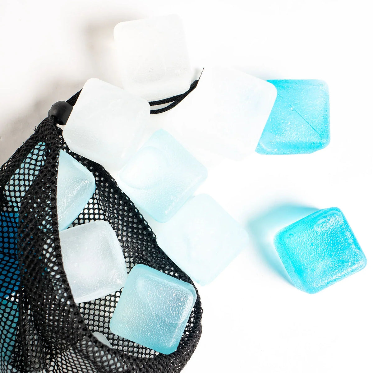 Large blue and clear Zero Ice reusable cubes beside the open mesh bag