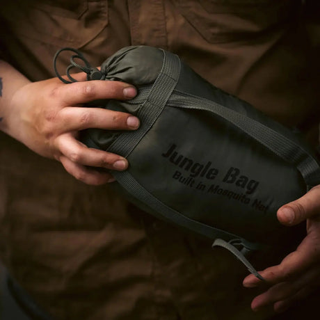 Snugpak Jungle Sleeping Bag - Held outdoors in compression sack