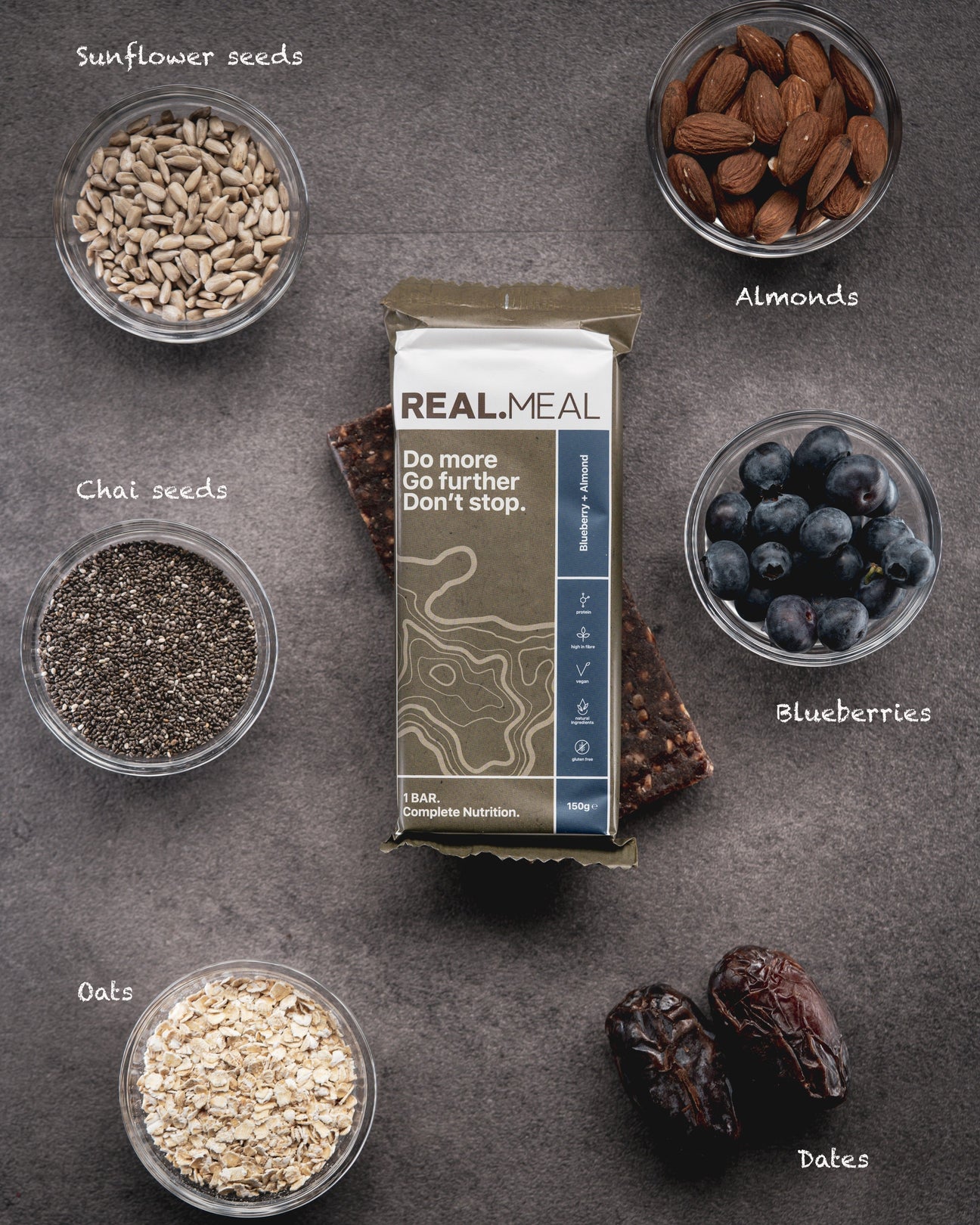 Real Meal Food Bars laid out on the ground with ingredients