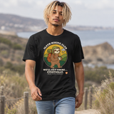 Man walking a coastal trail wearing the Sloth Hiking Club: Walking T-Shirt in Vintage Black