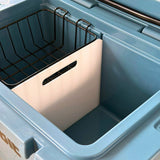 Inside the Orbie 35 cool box, with the black wire basket on the rails and the white divider in place