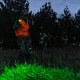 Hunter in long grass at dusk using the Ledlenser P6R Core QC green light