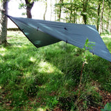 DD Tarp 3x3m in olive green pitched low showing the underside and ridge-line attachment points in woodland