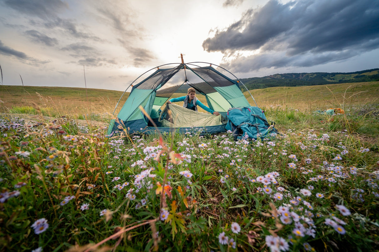 Kelty Wireless 4 Person Tent - pitched in a meadow with vehicle