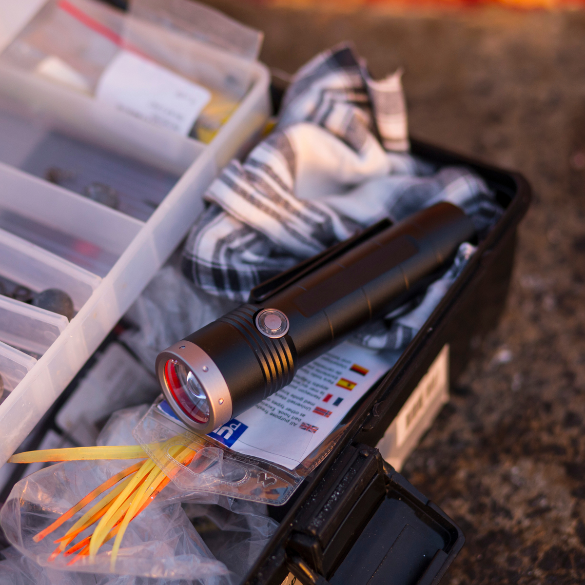 Ledlenser MT10 torch lying in an open fishing tackle box
