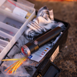 Ledlenser MT10 torch lying in an open fishing tackle box