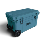 Orbie 55 wheeled cool box in Mountain Blue closed at an angle, showing a lid cup holder and the treaded wheels