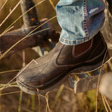 Mongrel 940030 Elastic Side Premium Chelsea Boot - Brown worn outdoors on a rural gate in a grassy paddock