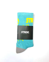 Stride Lucid Strike running sock folded in its black STRIDE card sleeve
