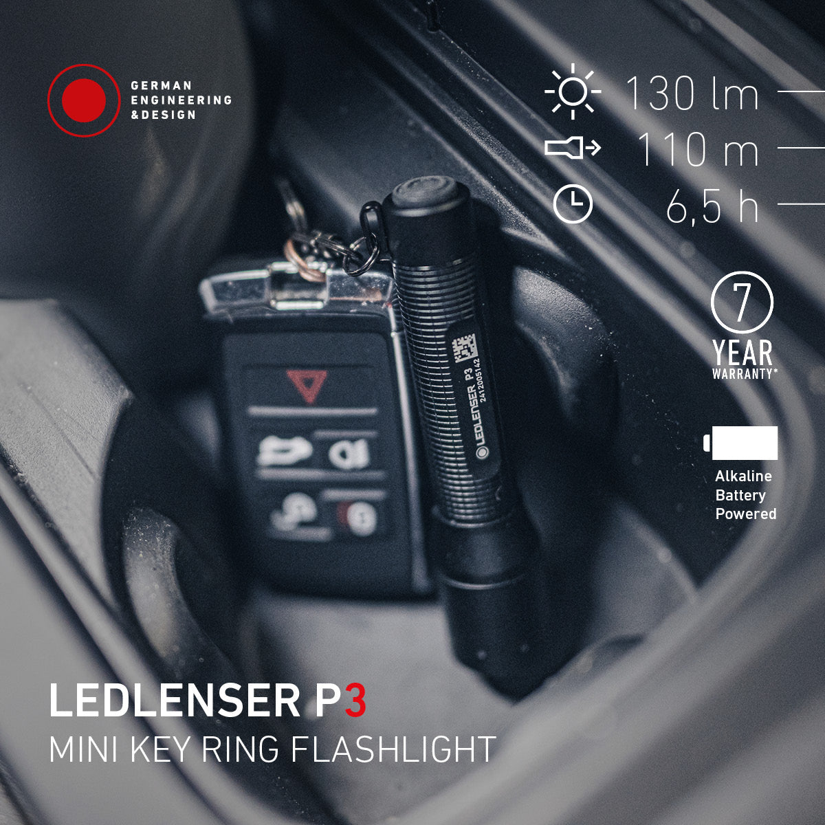 Ledlenser P3 keyring torch on a car key in a car console