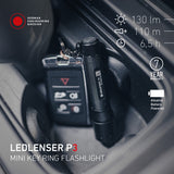 Ledlenser P3 keyring torch on a car key in a car console