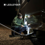 Man jacking up a caravan at night by the light of the Ledlenser MH10 SE
