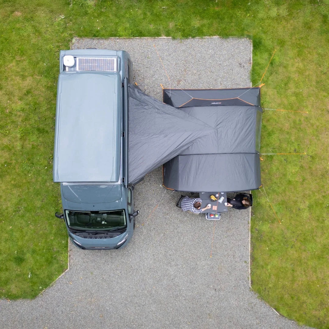 Aerial view of the Vango Cove III awning pitched beside a campervan